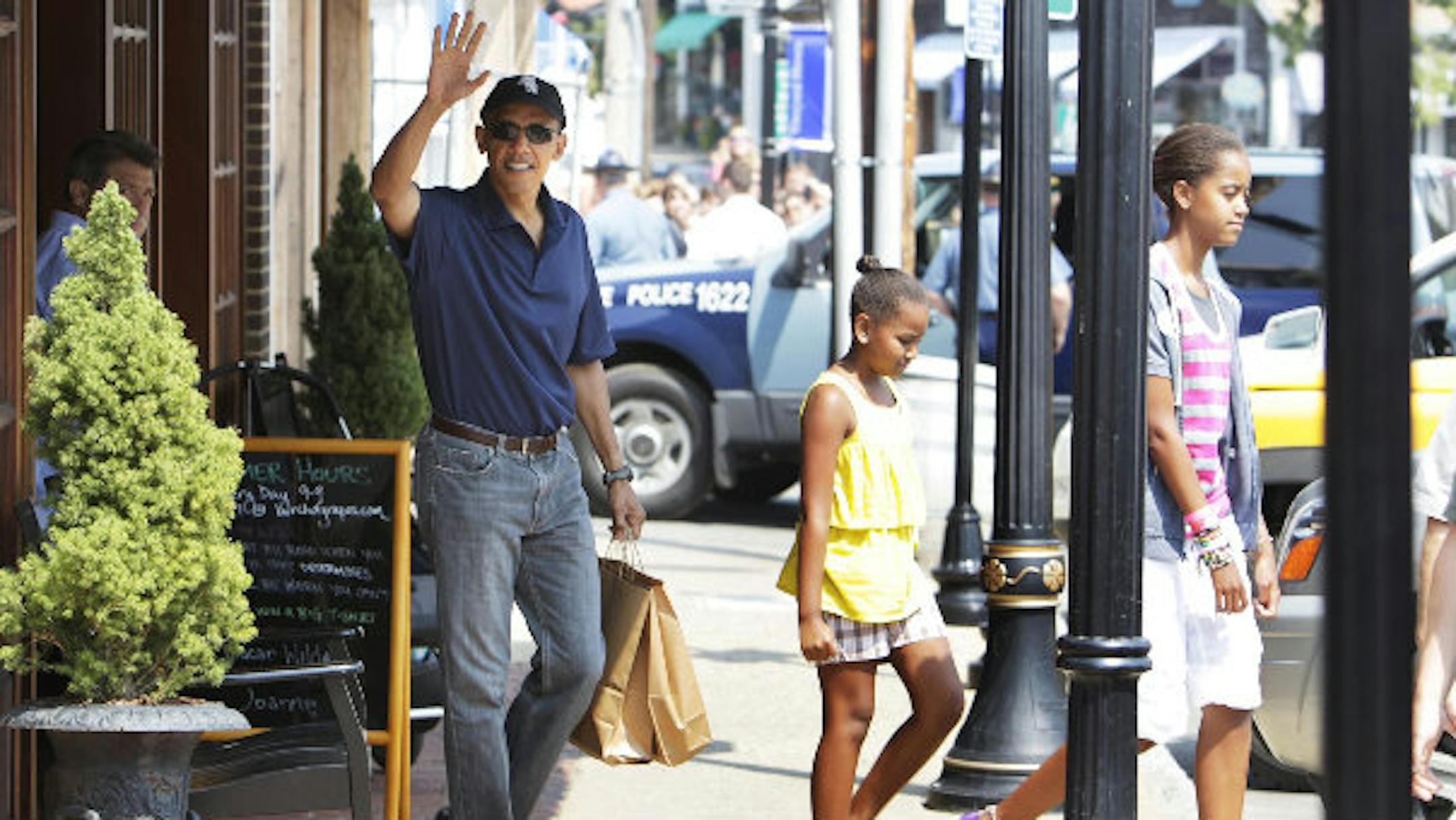 President Obama and his family leave A Bunch of Grapes Bookstore on Martha's Vineyard. Photo by the Associated Press.