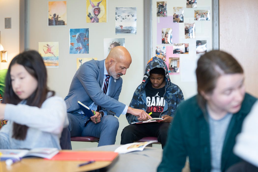 Joe Gothard, the St. Paul Public Schools Superintendent, helps Mathias McNeal with his reading exercise in Rosie Malone-Povolny’s WINN Reading class at American Indian Magnet School in St. Paul on April 3.