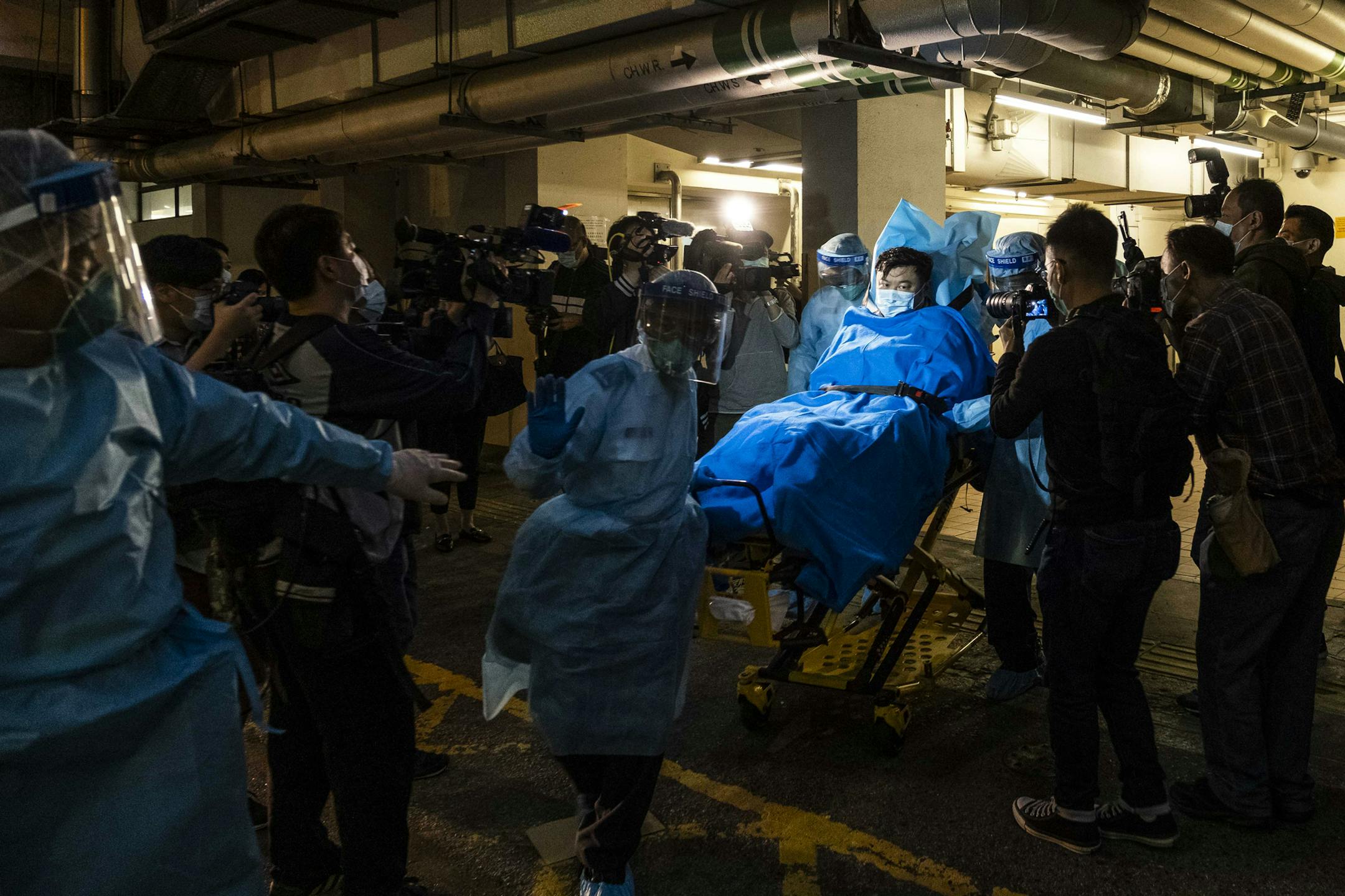 Paramedics transport a man believed to be Hong Kong’s first Wuhan coronavirus patient to a hospital on Wednesday, Jan. 22, 2019. Beijing has responded faster to the new threat than it did with SARS, but it still silences and punishes those who veer from the official line, with potentially damaging consequences. (Lam Yik Fei/The New York Times)