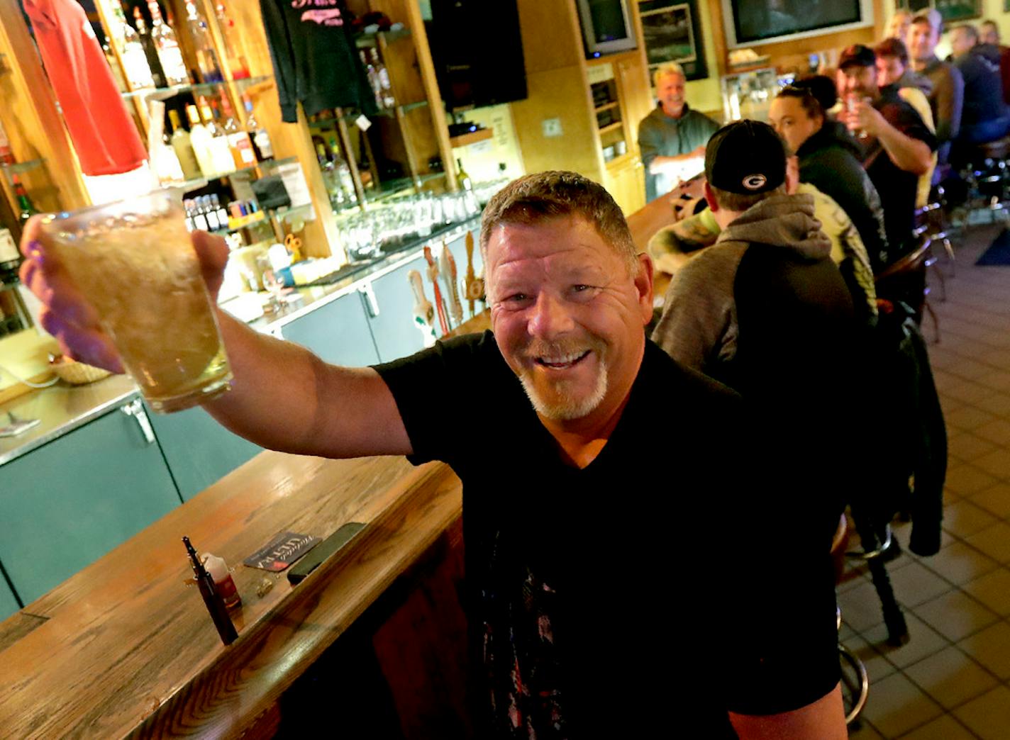 Marvin Radtke toasted the Wednesday opening of Appleton's Friends and Neighbors bar. City officials signed an order that took effect at 8 a.m. Thursday continuing the "safer at home" order.