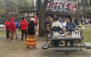 Community members gather at Cedar Field Park on Thursday after five people were killed by gunfire earlier in the week.