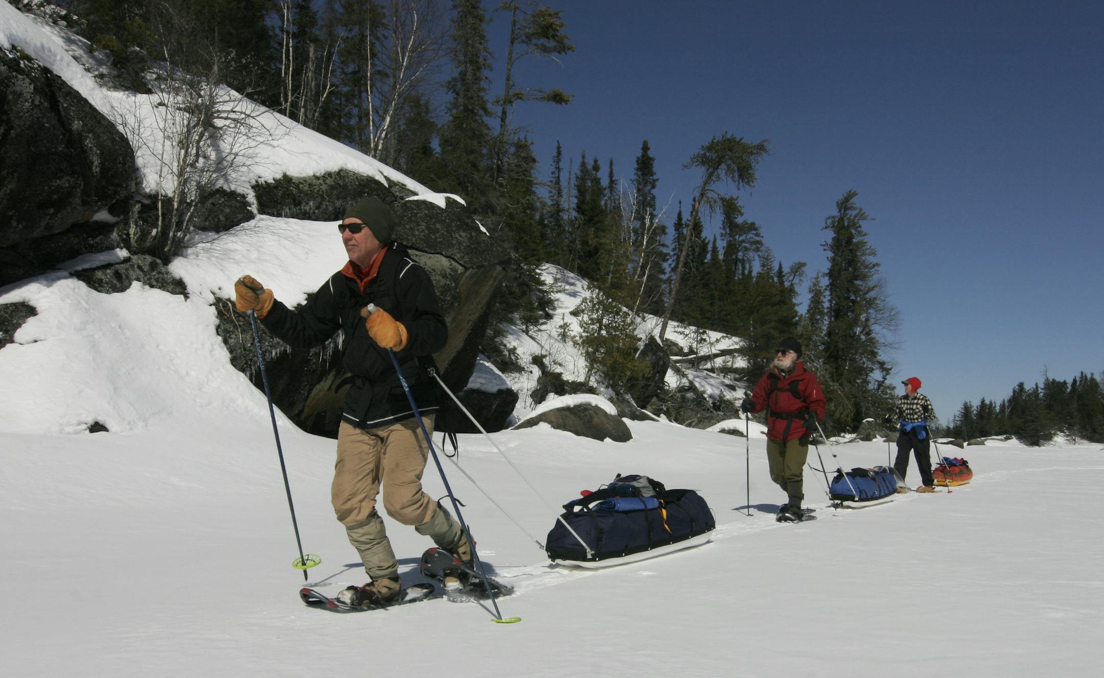 Pulling sleds loaded with caming gear, Steve Piragis, Gary Thornbloom and Sam Cook snowshoe across a frozen Boundary Waters Canoe Area Wilderness lake last weekend. Sub-zero temperatures at night froze slush and soft snow atop the lakes, making travel easier. Photo by Doug Smith/Star Tribune
