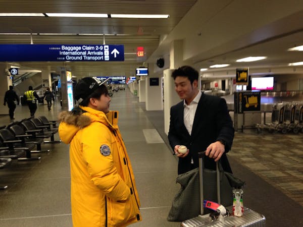 South Korean baseball player Byung Ho Park, right, arrived at Minneapolis-St. Paul International Airport on Sunday night, Nov. 29, 2015. Park arrived 