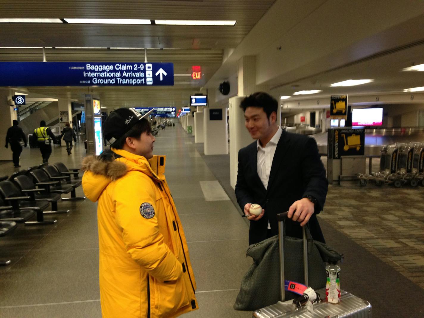 South Korean baseball player Byung Ho Park, right, arrived at Minneapolis-St. Paul International Airport on Sunday night, Nov. 29, 2015. Park arrived in the Twin Cities to finish off negotiations with the Twins, who have until Dec. 8 to sign the slugger.