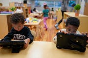 Children work on tablets during a preschool class at the Life Learning Center - Head Start, in Cincinnati.