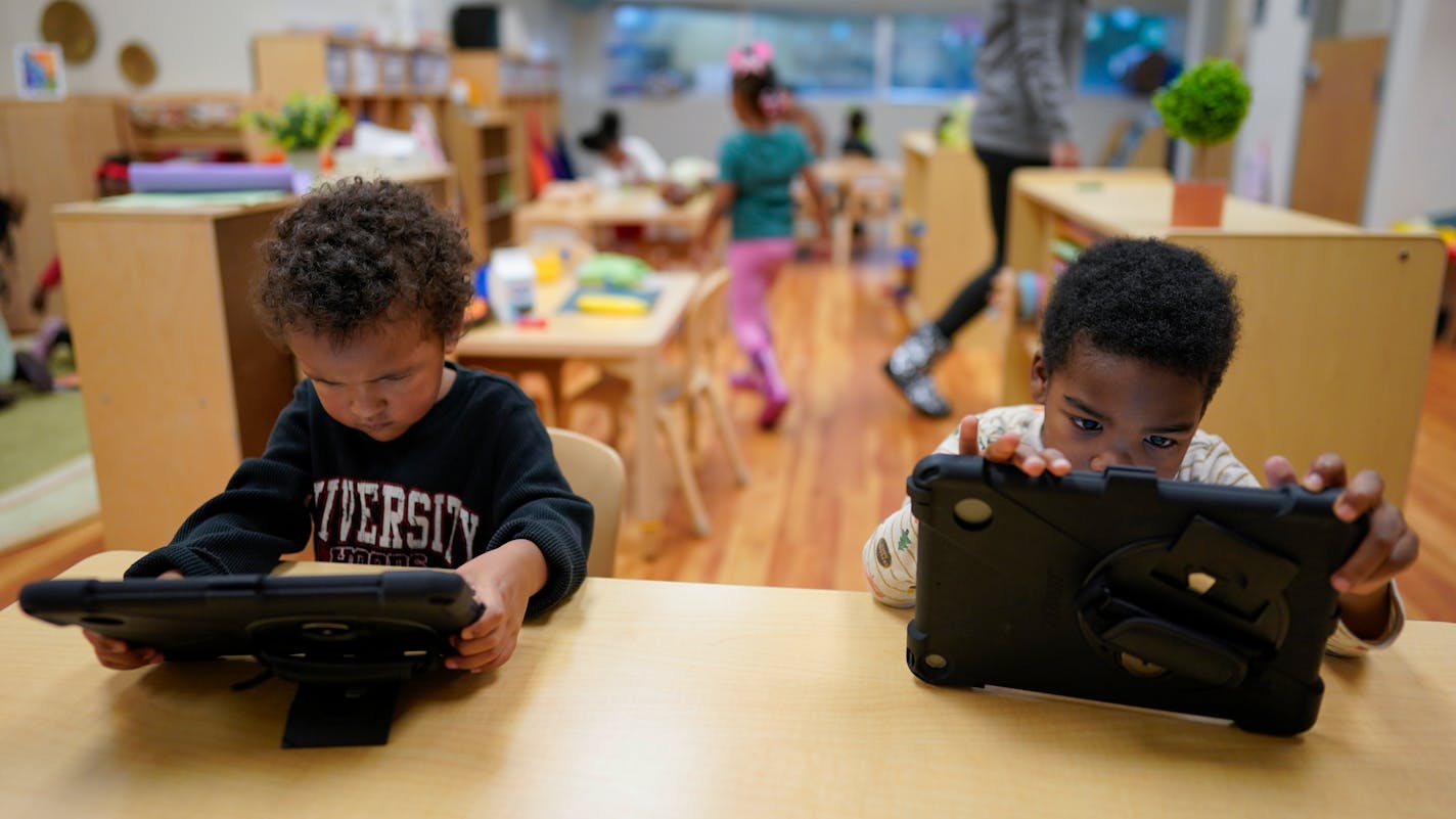 Children work on tablets during a preschool class at the Life Learning Center - Head Start, in Cincinnati.