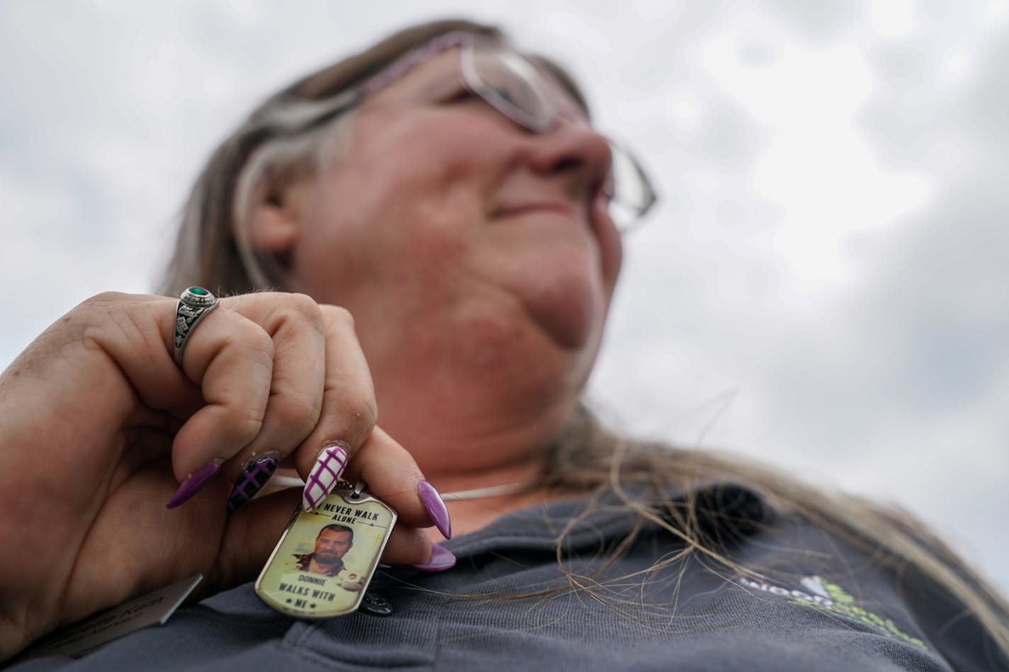 Janette Kern of Clarksville, Ind., wears a pendant with a photograph of her son Donnie DeJarnette, who died two years ago at age 25. MUST CREDIT: Washington Post photo by Jahi Chikwendiu