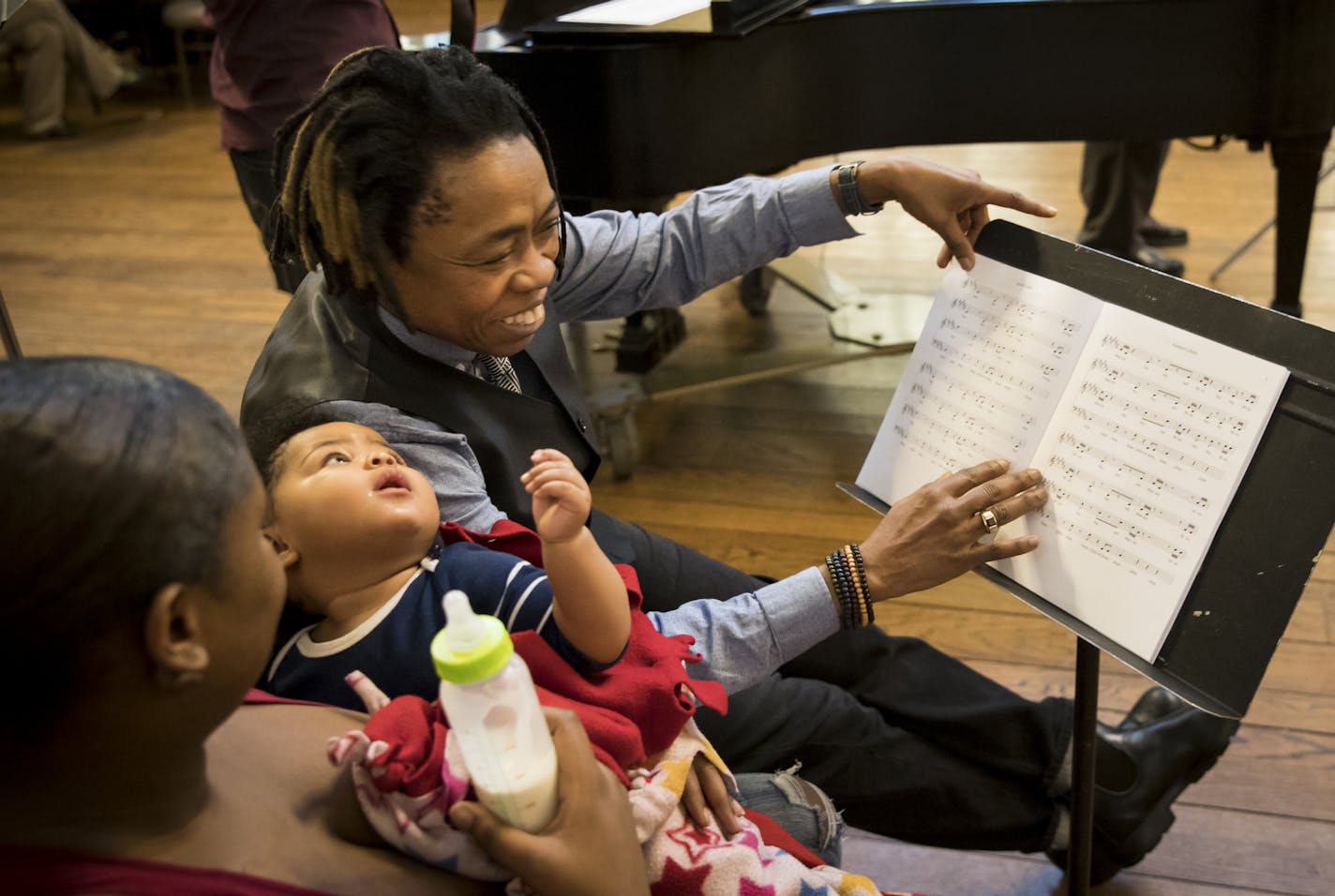 Guest artist Melanie DeMore pointed to the music as Amina Caver sat on her mother Arianna Caver's lap listening to a song for the first time Arianna had wrote for her as park of the Lullaby project at Plymouth Congressional Church on Tuesday, January 10, 2016, in Minneapolis, Minn. ] RENEE JONES SCHNEIDER &#x2022; renee.jones@startribune.com