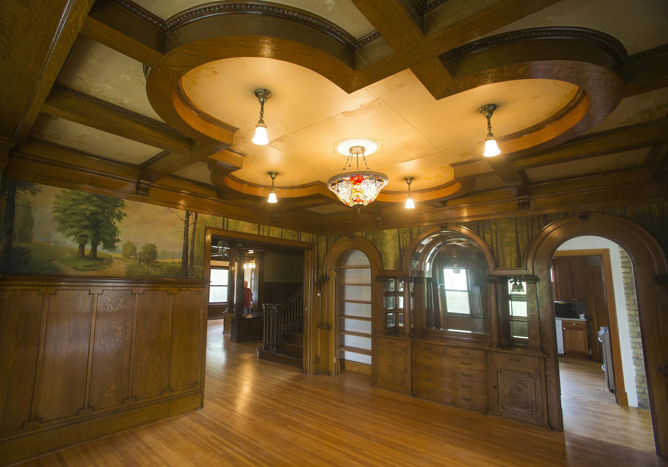 Exposed wood support beams as well as the forrest-themed mural give rooms such as this a warm and outdoor aesthetic. ] Timothy Nwachukwu • timothy.nwachukwu@startribune.com Klein Mansion owners Nick and Ann Johnson give a tour of the historic home on Monday, August 1, 2016 in Chaska. The mansion, built in 1911 by brickmaking businessman Charles Klein, is now listed for sale.