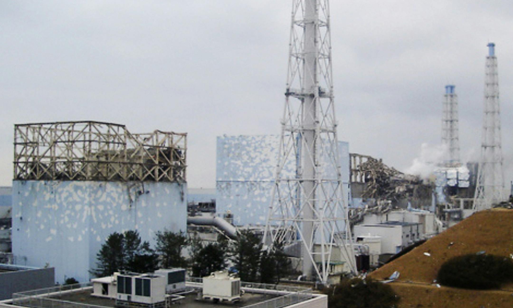 In this image released by Tokyo Electric Power Co., smoke billows from the No. 3 unit among four housings cover four reactors at the Fukushima Dai-ichi nuclear complex in Okumamachi, Fukushima Prefecture, northeastern Japan, on Tuesday, March 15, 2011. Japan ordered emergency workers to withdraw from its stricken nuclear complex Wednesday amid a surge in radiation, temporarily suspending efforts to cool the overheating reactors. Hours later, officials said they were preparing to send the team ba