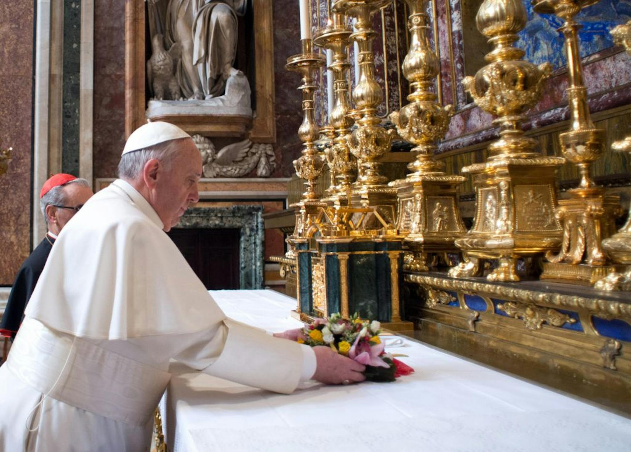 On his first day on the job, Pope Francis put flowers on the altar inside a basilica dedicated to Jesus' mother, Mary. He also spent time praying there.