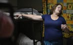 Domestic violence survivor Susan Contreras talks about her abuse as she stands by her bed in a Phoenix-area shelter for victims of domestic violence o