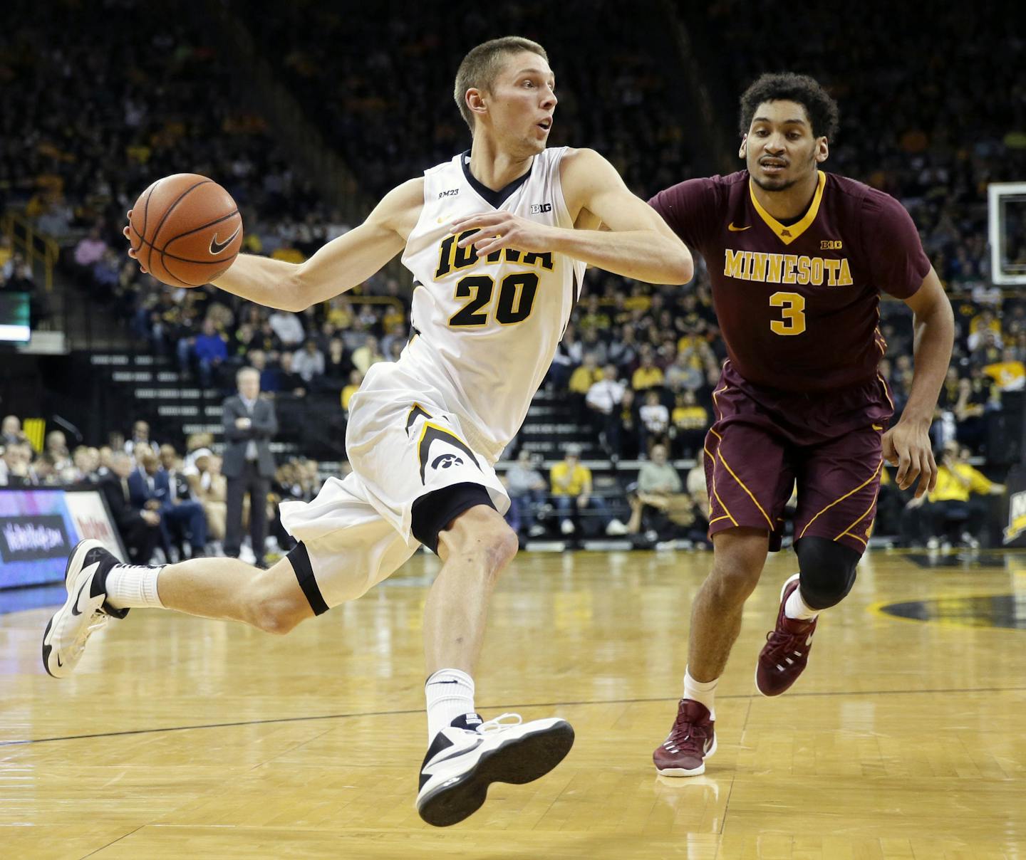 Iowa forward Jarrod Uthoff drives to the basket past Minnesota forward Jordan Murphy, right, during the first half of an NCAA college basketball game, Sunday, Feb. 14, 2016, in Iowa City, Iowa. (AP Photo/Charlie Neibergall)