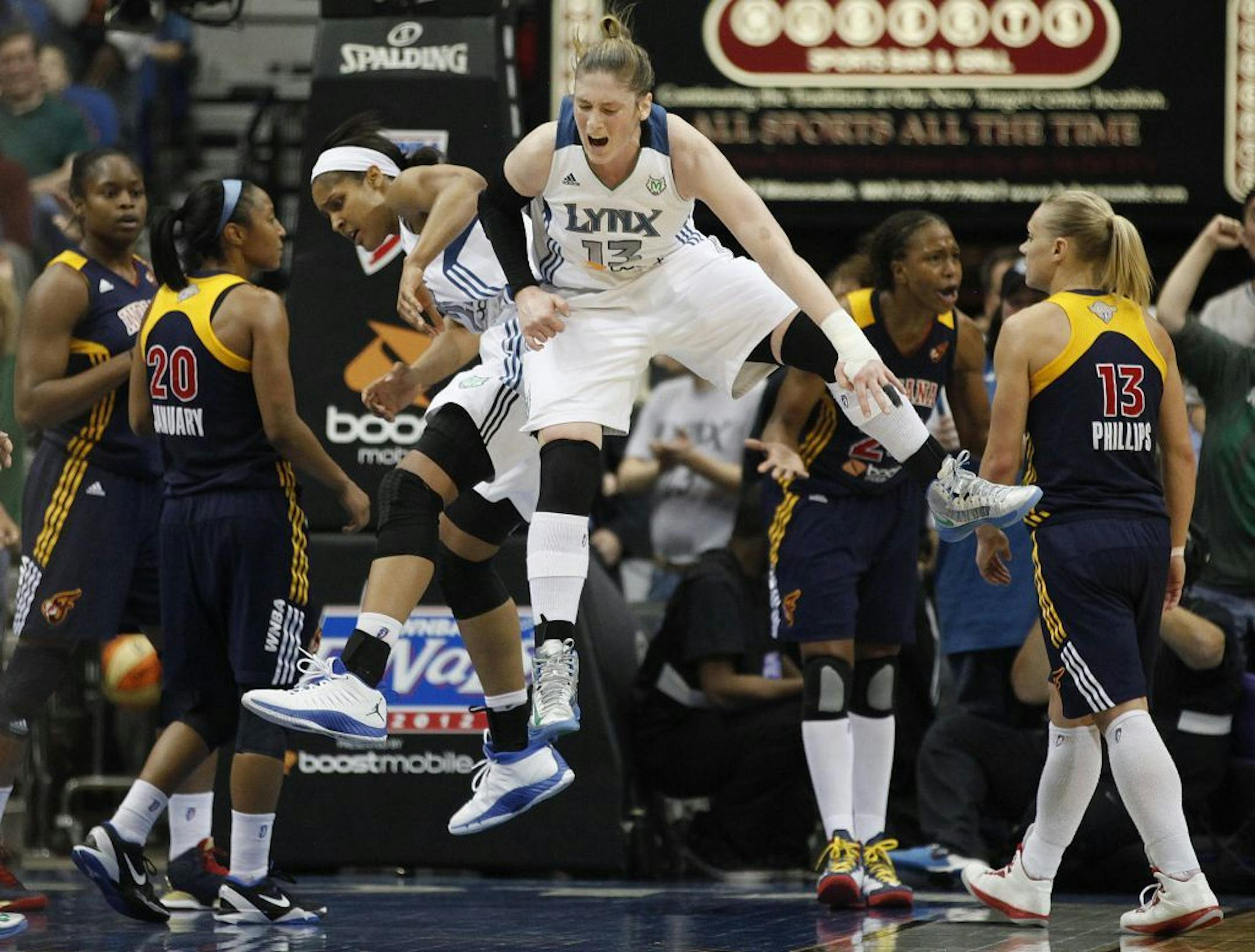 Maya Moore and Lindsay Whalen celebrate after a scoring play against the Indiana Fever.