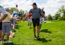 Phil Mickelson slapped hands of young fans after playing the first of a few practice holes on Tuesday at TPC Twin Cities in Blaine.