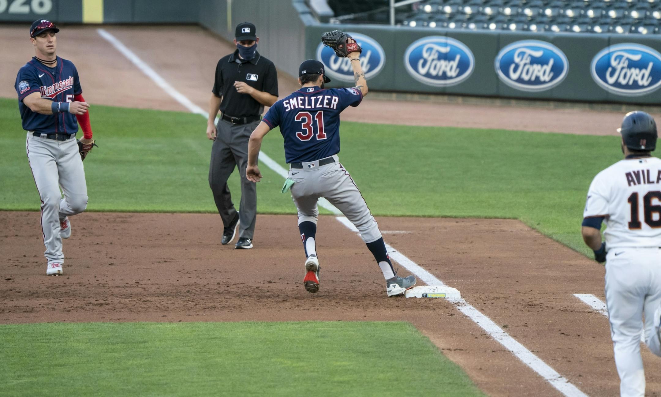 Twins starting pitcher Devin Smeltzer (31) got catcher Alex Avila (16) out at first in the third inning of a scrimmage at practice at Target Field in Minneapolis, Minn., on Wednesday, July 15, 2020.