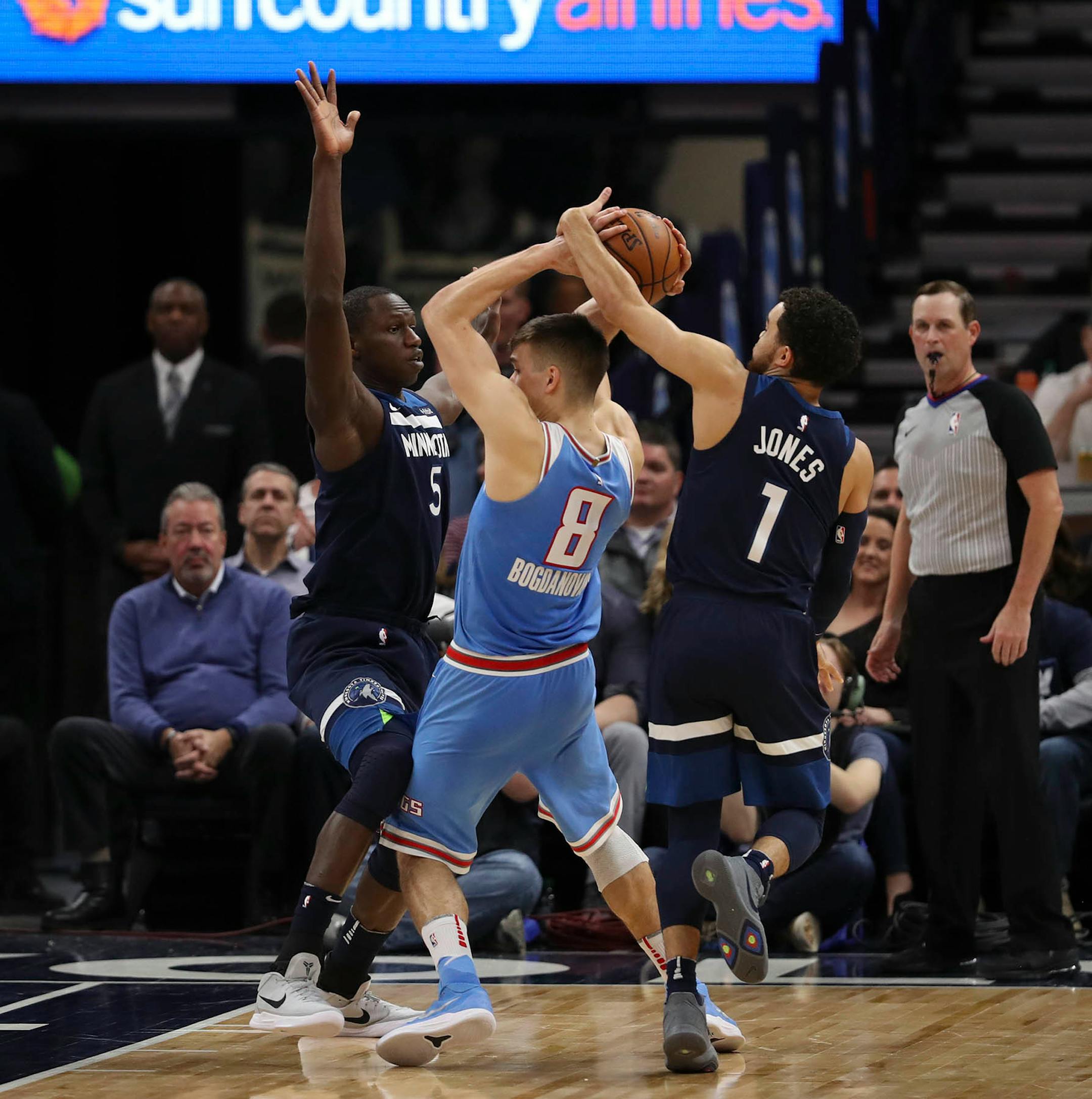 Minnesota Timberwolves guard Tyus Jones (1) stripped the ball from Sacramento Kings guard Bogdan Bogdanovic (8) while he was distracted by Minnesota Timberwolves center Gorgui Dieng (5) in the fourth quarter. ] JEFF WHEELER • jeff.wheeler@startribune.com The Minnesota Timberwolves extended their home winning streak to a lucky 13 with their 111-106 win over the Sacramento Kings in an NBA basketball game Sunday evening, February 11, 2018 at Target Center in Minneapolis.