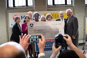 Elected officials posed with a ceremonial check for $239,345,549 for group photos Tuesday, April 11, 2023 St. Paul, Federal Transit Administrator Nuri