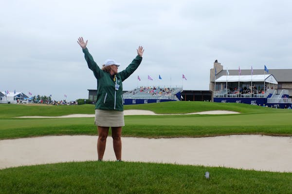 A marshal quieted the crowd on the 18th green as golfers putted Saturday. ] ANTHONY SOUFFLE • anthony.souffle@startribune.com Golfers took part in t