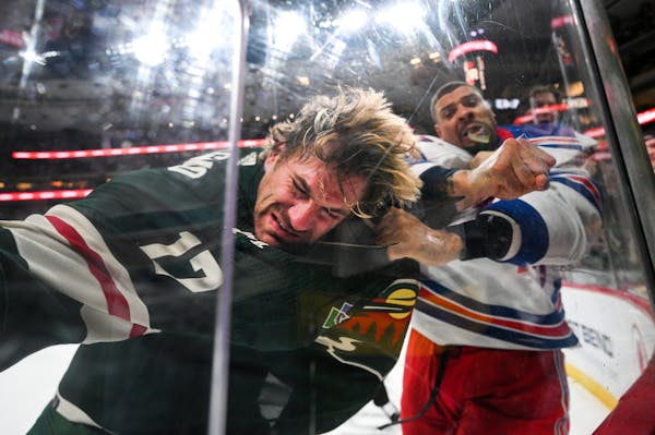 New York Rangers right wing Ryan Reaves (75) punches Minnesota Wild left wing Marcus Foligno (17) as the two fight in the third period Thursday, Oct. 
