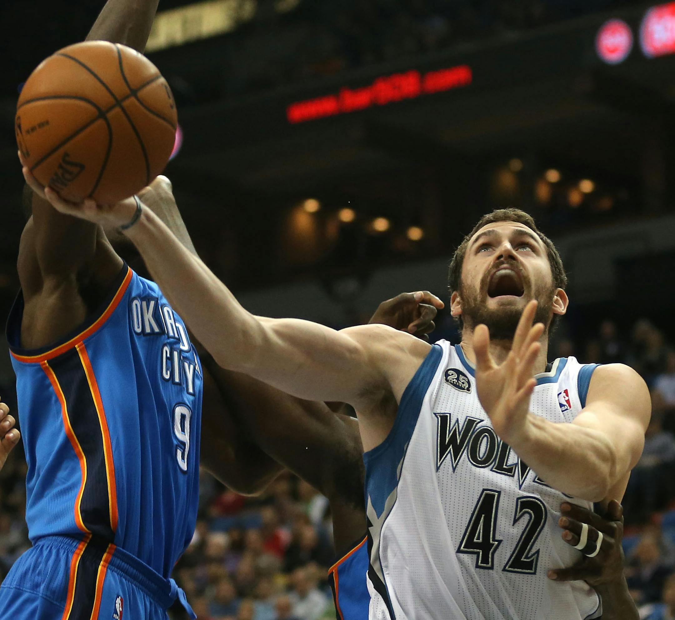 Wolves Kevin Love slipped past the defense of the Thunder’s Serge Ibaka during the first half.