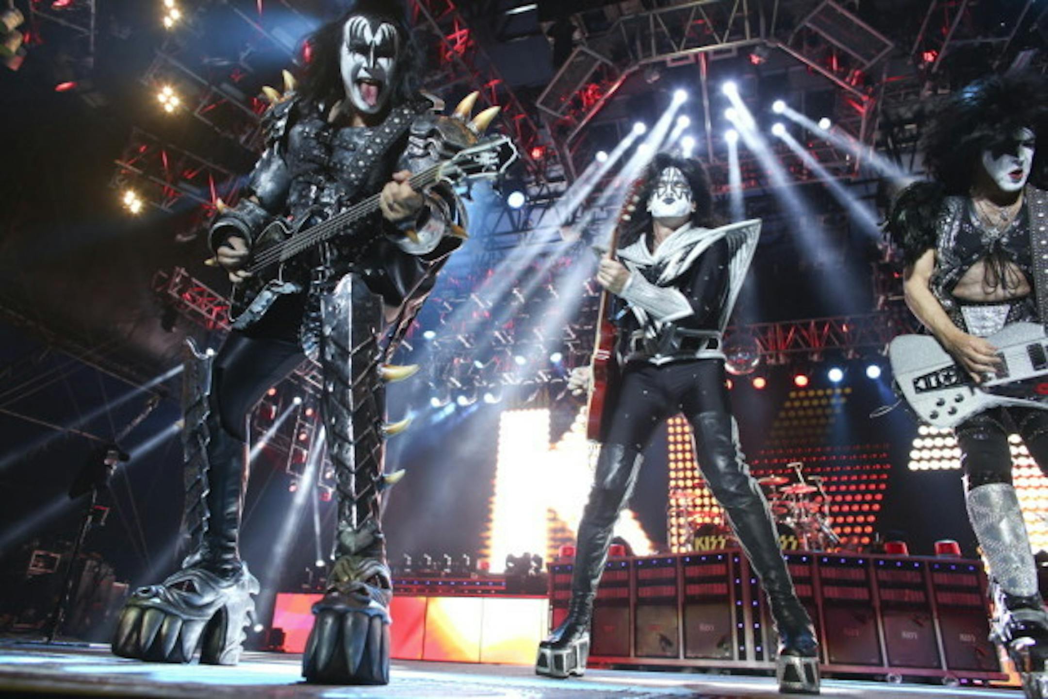 Gene Simmons, left, probably licked up a mosquito with Tommy Thayer and Paul Stanley at the Minnesota State Fair grandstand in 2012. / Kyndell Harkness, Star Tribune