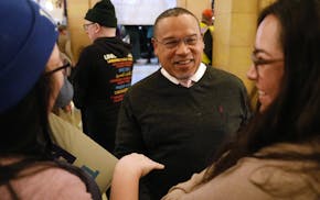 Minnesota Attorney General Keith Ellison talks with supporters after speaking at the “Fund Our Future” rally calling for elected officials to bloc