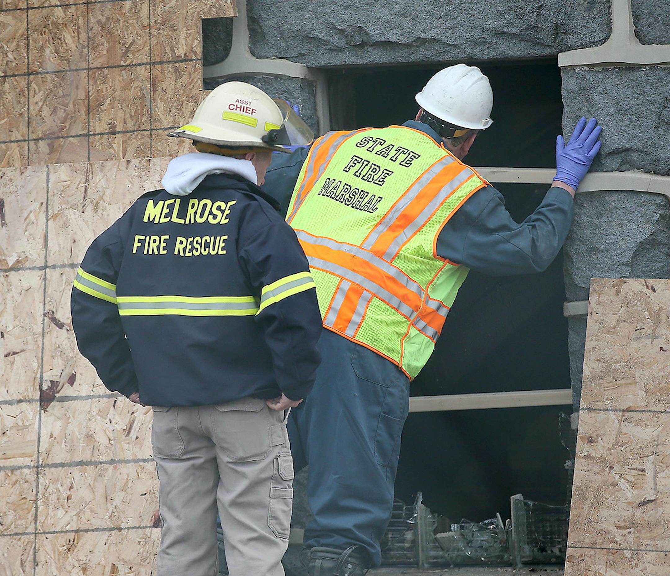 The March 2016 arson fire, at top, attracted a crowd. Hours later, federal agents joined local fire officials to inspect the damage.