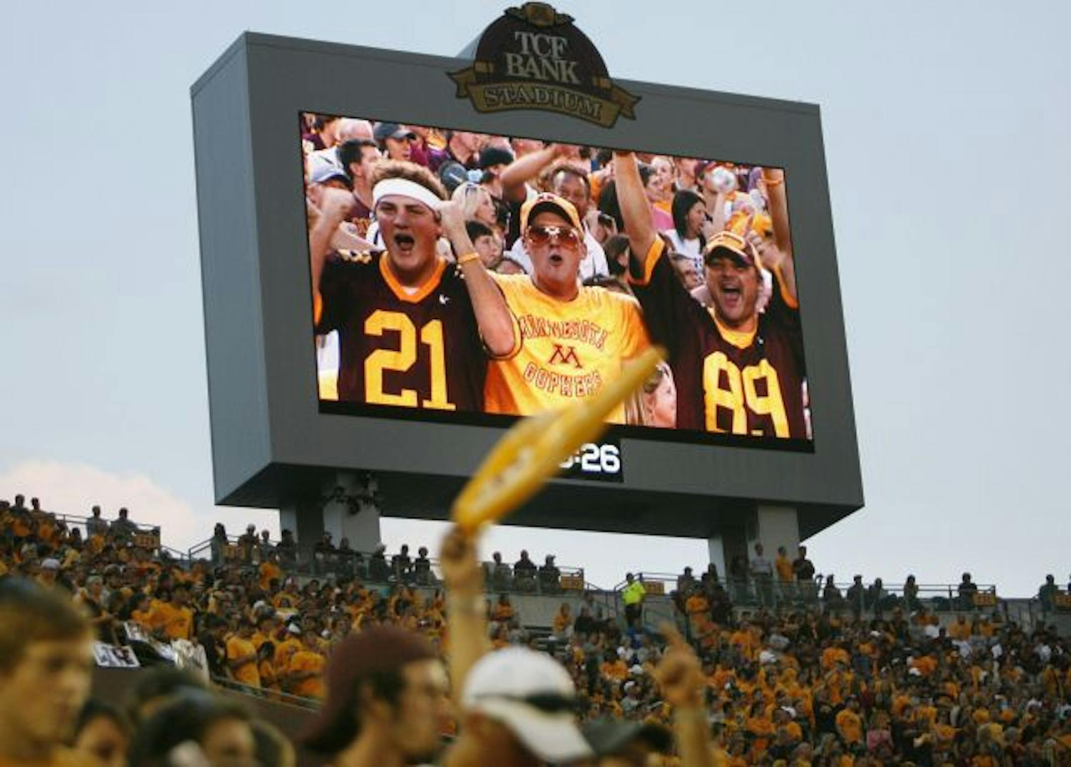 The Minnesota Gopher football team played their inaugural game in the new TCF Bank Stadium, taking on Air Force. Here, Gopher fans seen on a stadium large screen sense a win over Air Force.
