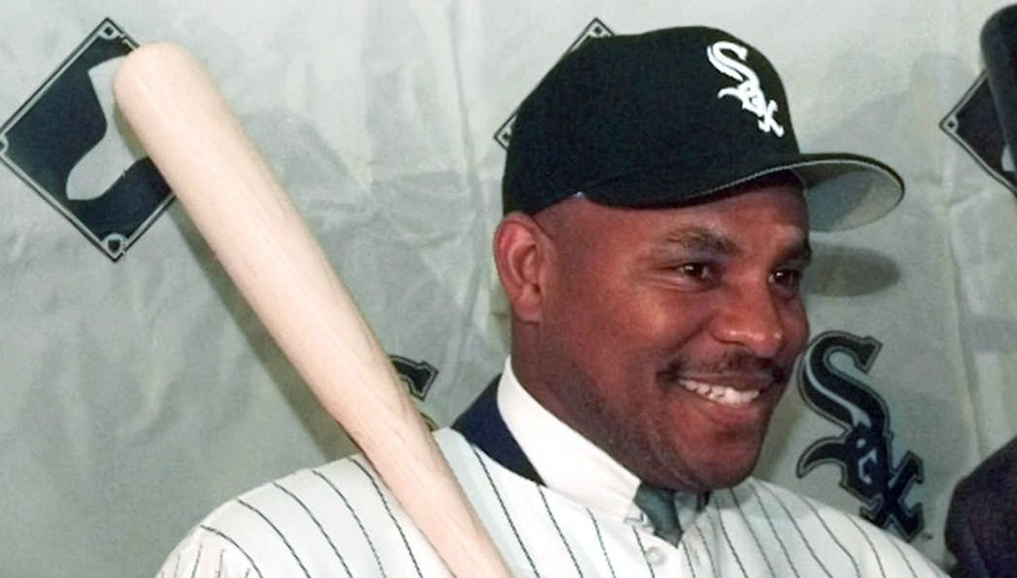 Albert Belle poses with new teammate Frank Thomas, right, at a news conference in Chicago on Tuesday, Nov. 19, 1996, after signing with the White Sox. The former Cleveland Indian was signed to a five-year contract, plus a one-year option. (AP Photo/Charles Bennett) ORG XMIT: CX104