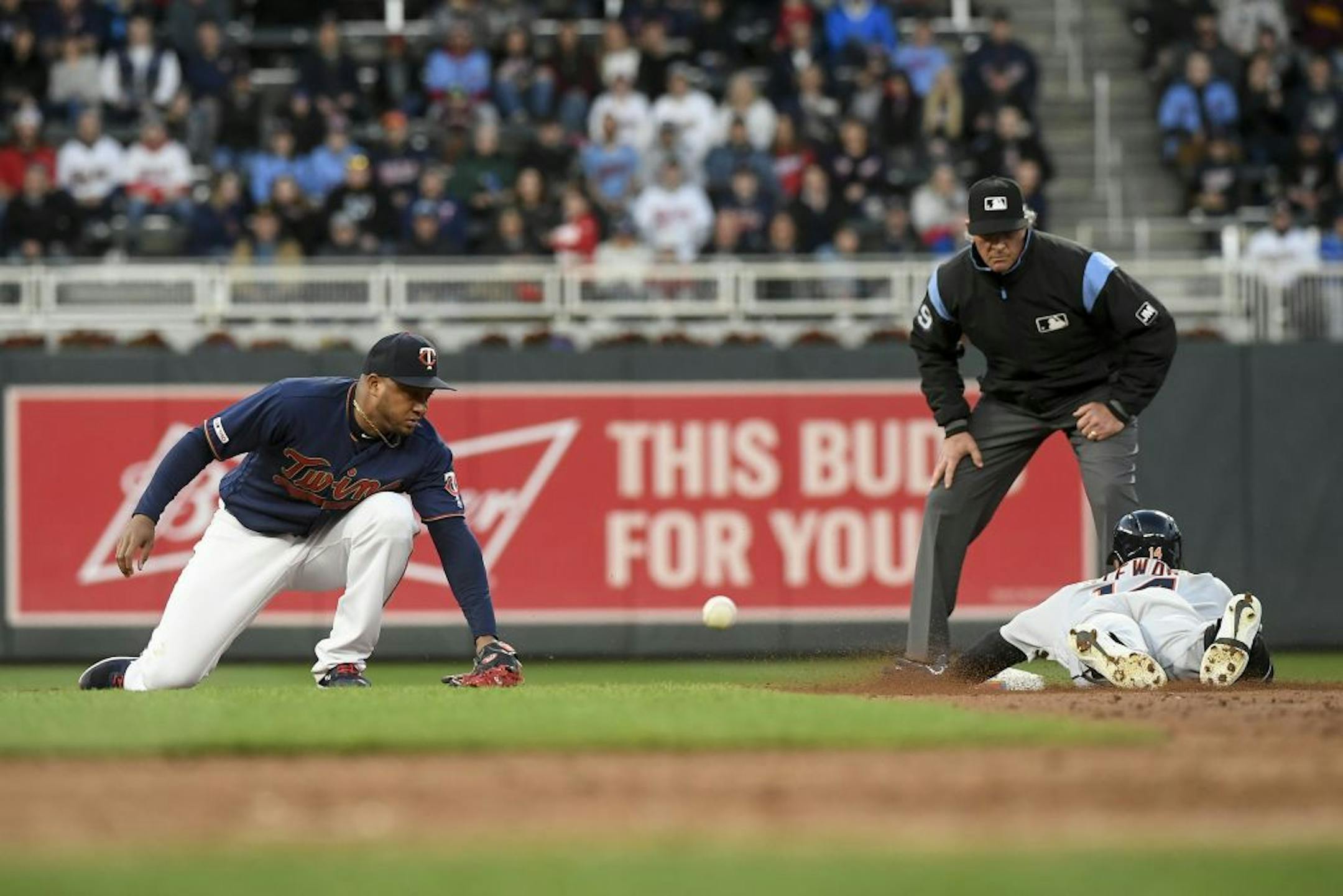 Minnesota Twins second baseman Jonathan Schoop (16) was unable to make the tag as Detroit Tigers left fielder Christin Stewart (14) slid into second after hitting a double to left field in the top of the third inning.