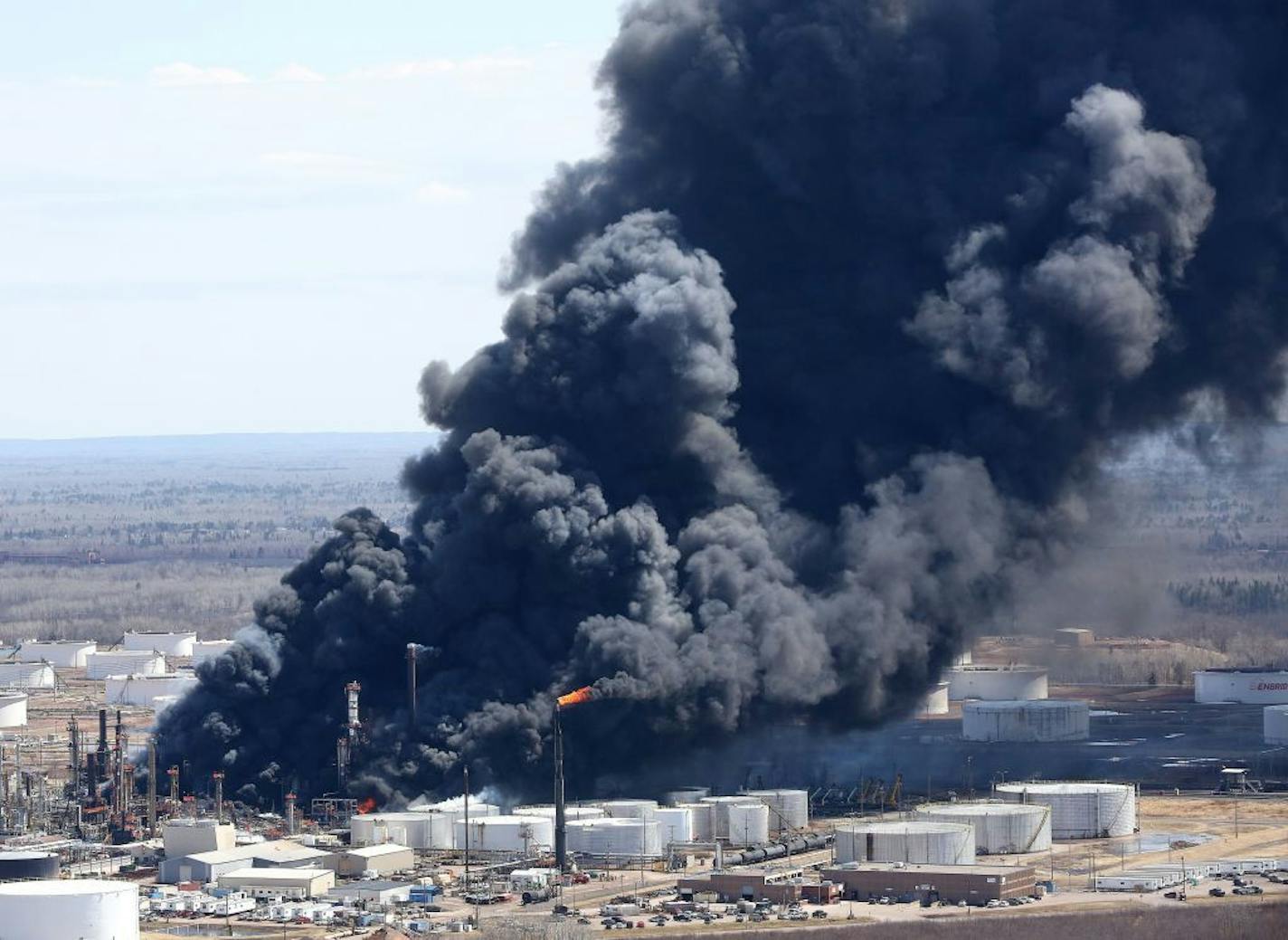 Thick smoke pours from the fire at the Husky Energy oil refinery in Superior, Wis., on Thursday afternoon.