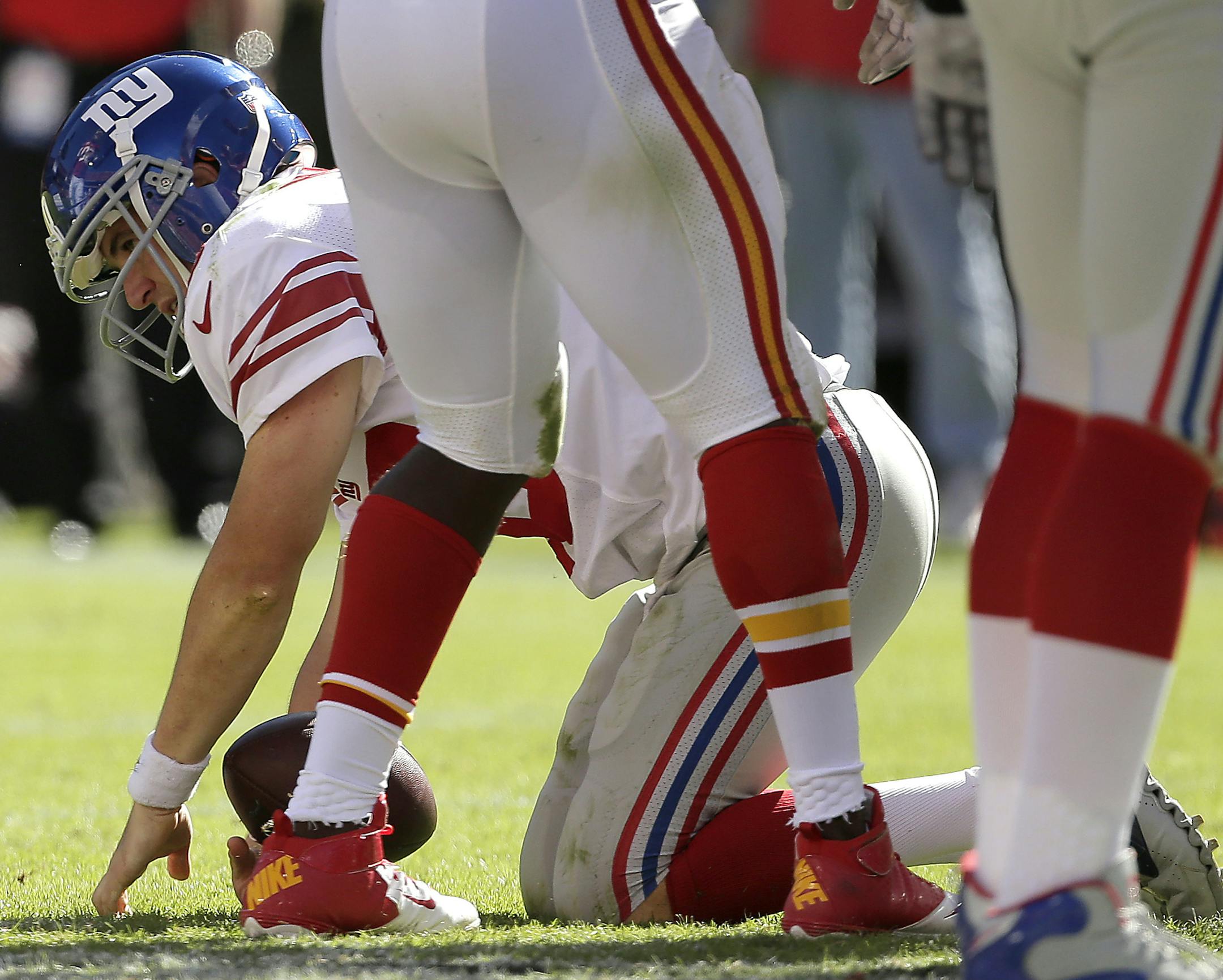 New York Giants quarterback Eli Manning (10) gets up after getting sacked during the second half of an NFL football game against the Kansas City Chiefs Sunday, Sept. 29, 2013, in Kansas City, Mo. The Chiefs won the game 31-7. (AP Photo/Charlie Riedel) ORG XMIT: MOOW