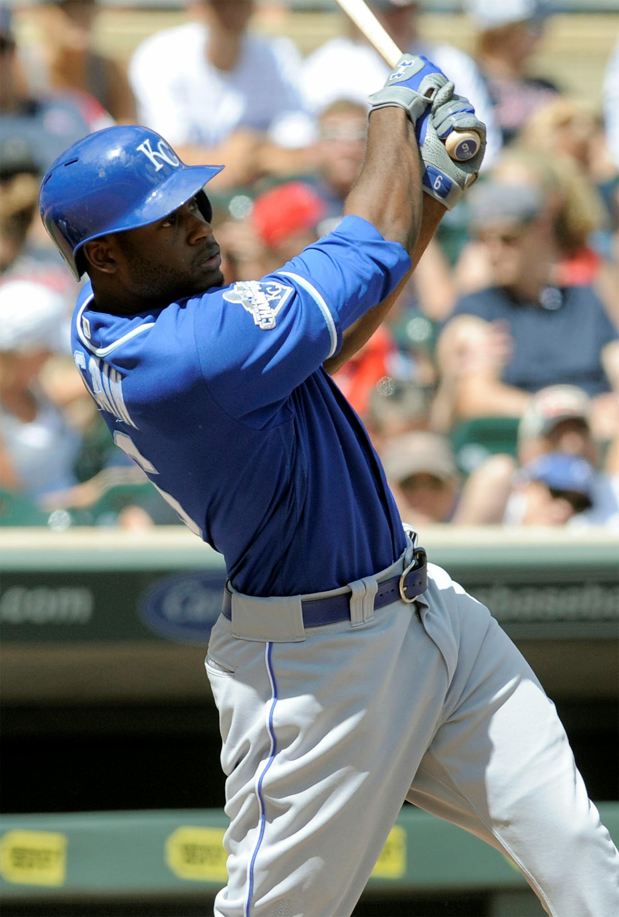 Kansas City Royals' Lorenzo Cain follows through with a double off Minnesota Twins pitcher Hector Santiago during the fourth inning of a baseball game, Sunday, Aug. 14, 2016, in Minneapolis.