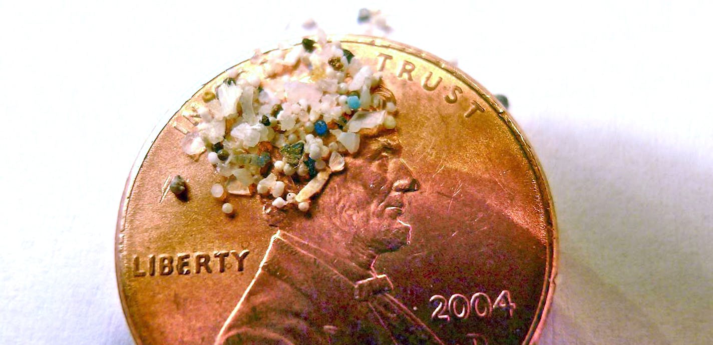 FILE - In this 2012 file photo provided by 5gyres.org, a sample of "microbeads" collected in eastern Lake Erie is shown on the face of a penny. Illinois environmentalists expecting a battle with business over a call for a ban on the tiny bits of plastic used in personal care products, found the industry quickly collaborated. With similar bans pending in at least three other large states, the extinction of microbeads, now showing up inside fish that are caught for human consumption, is happening