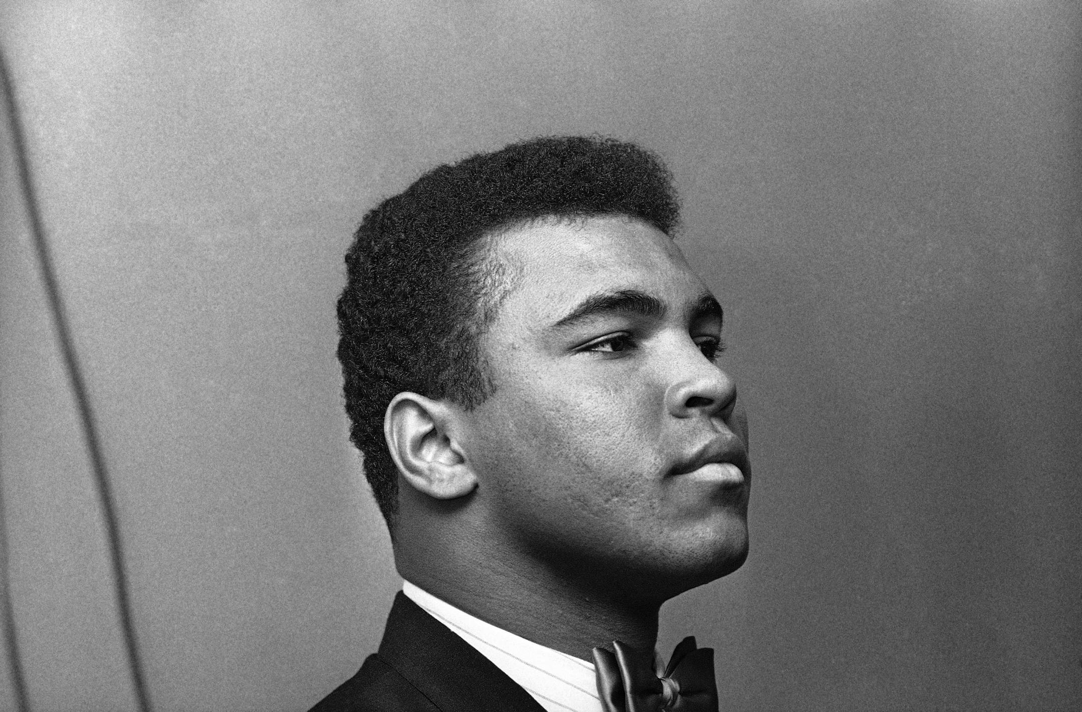 Muhammad Ali, heavyweight champion, buttons his lip as he appears before Illinois Athletic Commission in Chicago, Feb. 25, 1966. Previously, he?d said imminent army induction was unfair - touching off series of events leading to the commission reconsidering its sanction of Clay?s scheduled title defense later this month. (AP Photo) ORG XMIT: APHS283258