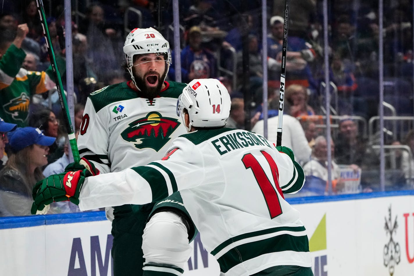 Minnesota Wild's Pat Maroon (20) celebrates with teammate Joel Eriksson Ek (14) after scoring a goal during the first period of an NHL hockey game against the New York Islanders Tuesday, Nov. 7, 2023, in Elmont, N.Y. (AP Photo/Frank Franklin II)