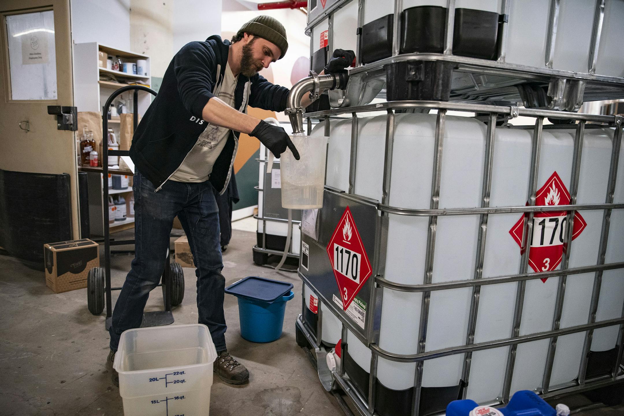 Steven Sola, the processing director at Vikre Distillery, measured out alcohol to be mixed and denatured into sprayable hand sanitizer on Tuesday. ]
ALEX KORMANN &#x2022; alex.kormann@startribune.com Vikre Distillery in Duluth, MN has joined other distilleries across the country and started to make sprayable hand sanitizer. They are offering to fill up any and all containers for community members for free and also have small picket size spray bottles they will fill and give out to those who need