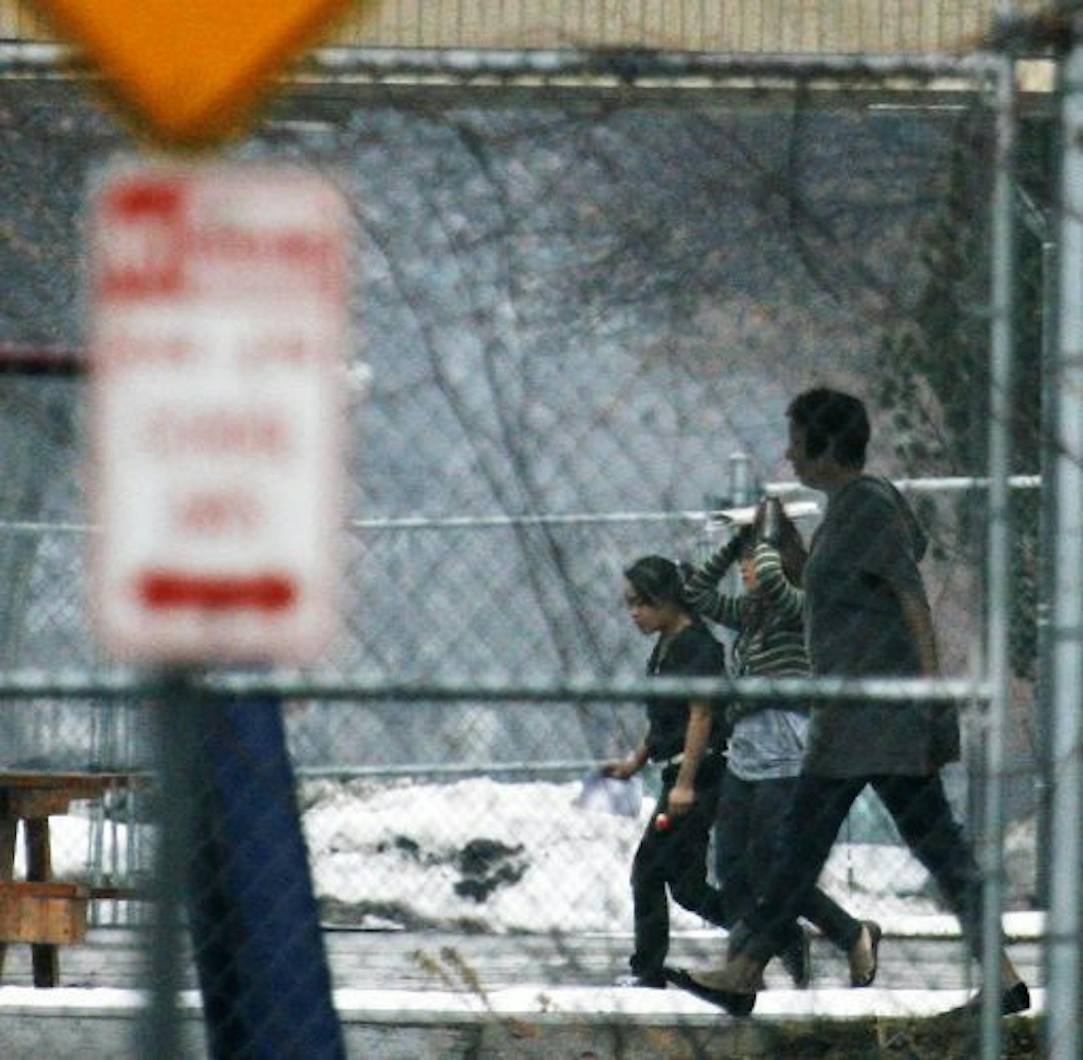 North High students pass between classes in the rain.