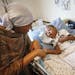 Fardosa Ibrahim rubbed her 4-year-old son Khalid hand as he rested in his bed. Fardosa is a educated nurse from Dubai and originally from Somalia, and