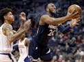 Minnesota Timberwolves guard Josh Okogie (20) drives to the basket as Phoenix Suns forward Kelly Oubre Jr. defends during the first half of an NBA bas