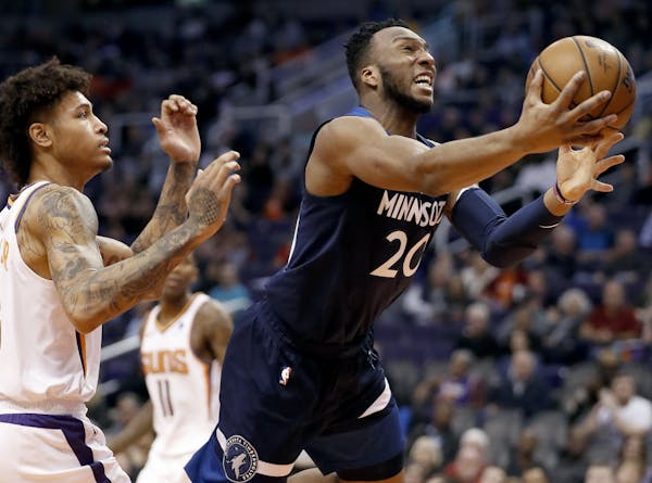 Minnesota Timberwolves guard Josh Okogie (20) drives to the basket as Phoenix Suns forward Kelly Oubre Jr. defends during the first half of an NBA bas