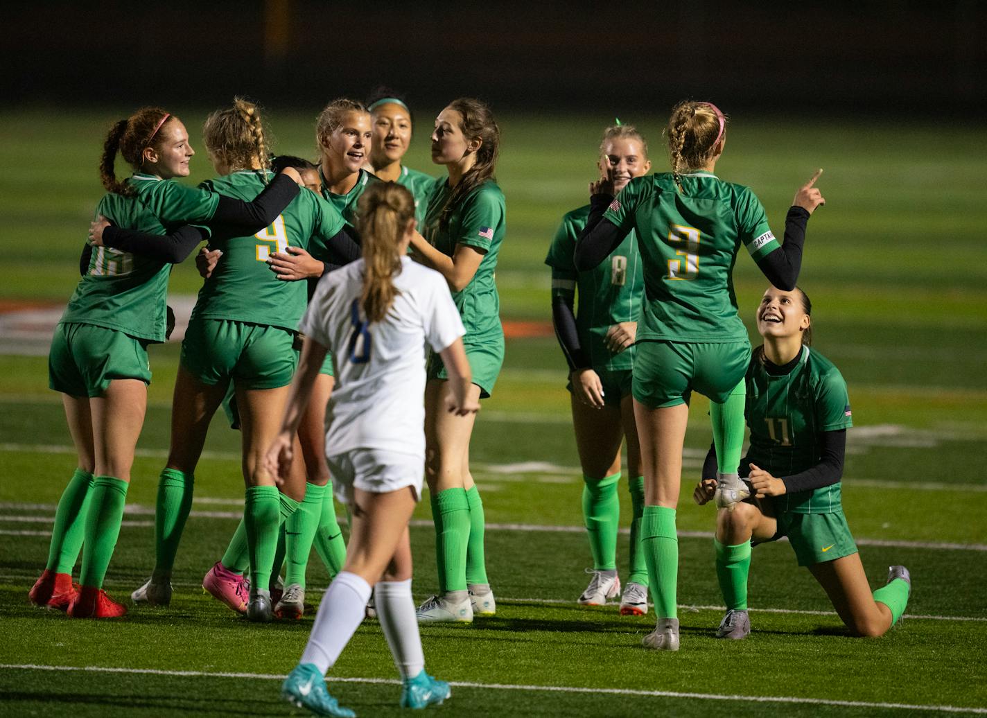 Edina's Izzy Engle (3) celebrated with a shoe shine from Lou Ruffien after she scored the second goal of her hat trick in the second half.