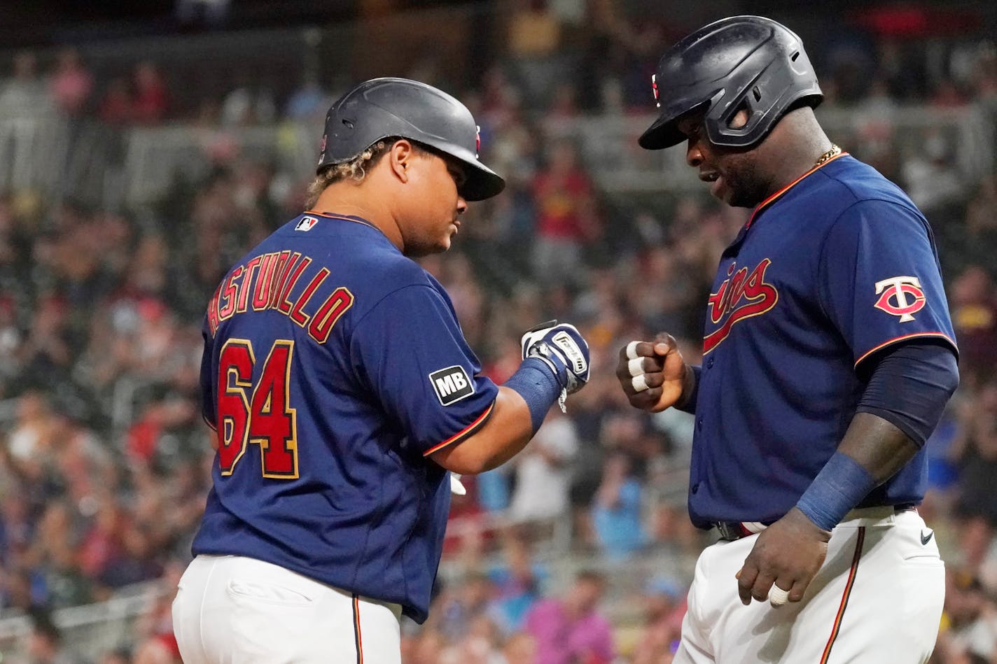 Minnesota Twins' Willians Astudillo (64) is congratulated by Miguel Sano following his two-run home run off Chicago White Sox pitcher Dallas Keuchel during the sixth inning of a baseball game Tuesday, Aug. 10, 2021, in Minneapolis. (AP Photo/Jim Mone)