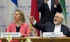 Iranian Foreign Minister Mohammad Javad Zarif, right, sits next to European Union High Representative Federica Mogherini during a plenary session at t