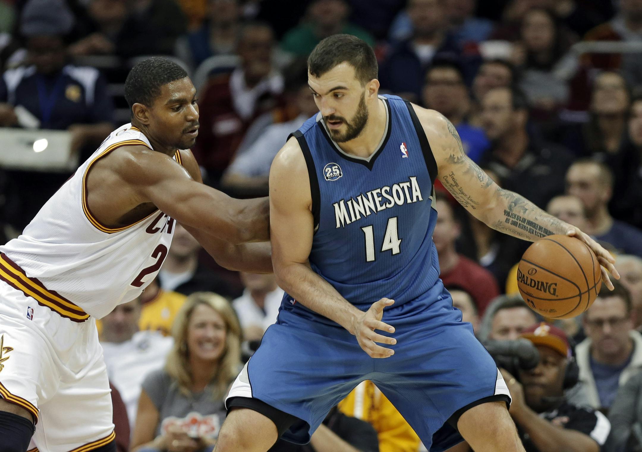 Cleveland Cavaliers' Andrew Bynum, left, defends Minnesota Timberwolves' Nikola Pekovic (14), from Montenegro, in the second quarter of an NBA basketball game Monday, Nov. 4, 2013, in Cleveland. (AP Photo/Mark Duncan)