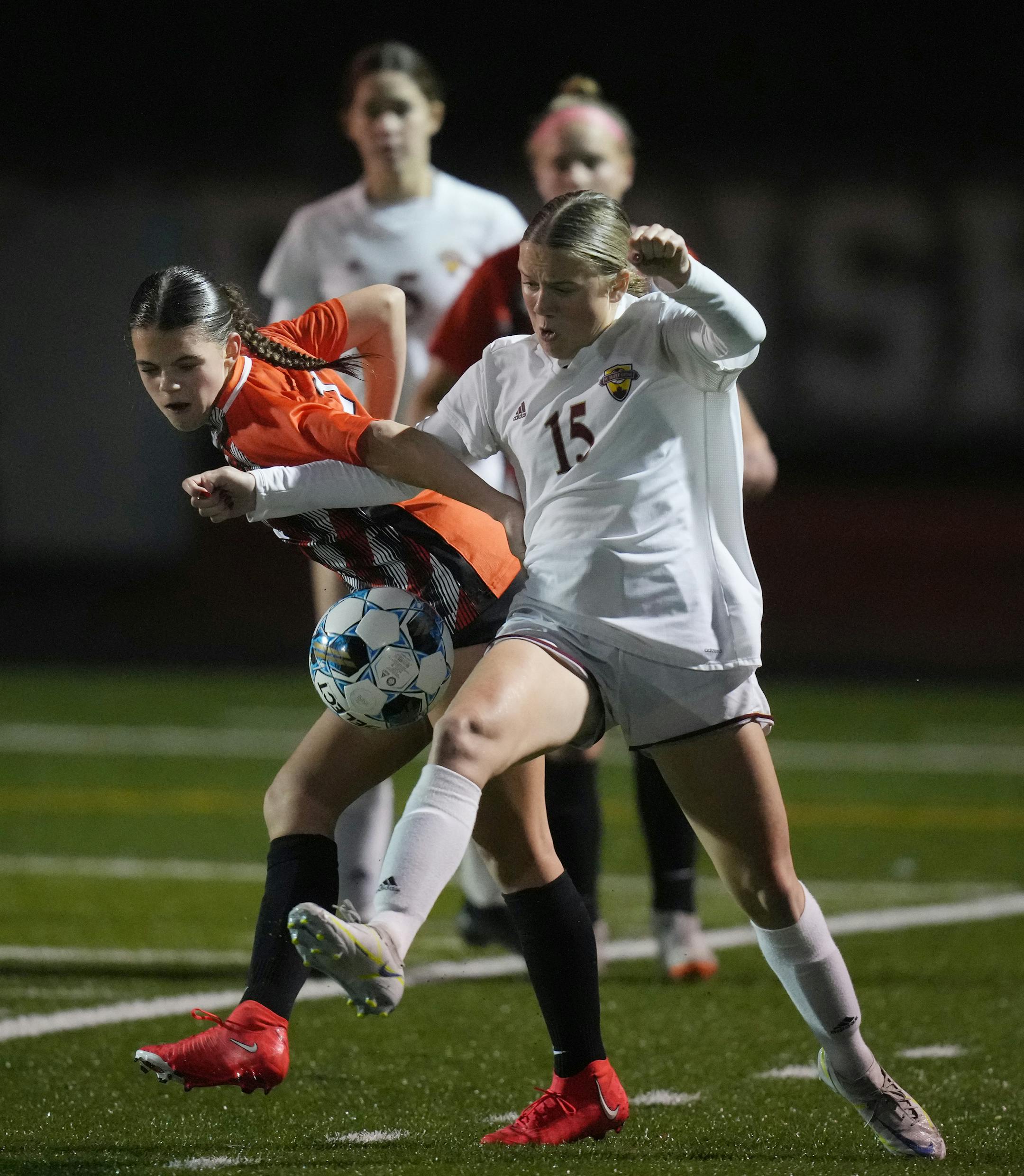 Ellyse Oelker (2) of White Bear fights for the ball with Abbey Oakland (15) of Maple Grove.