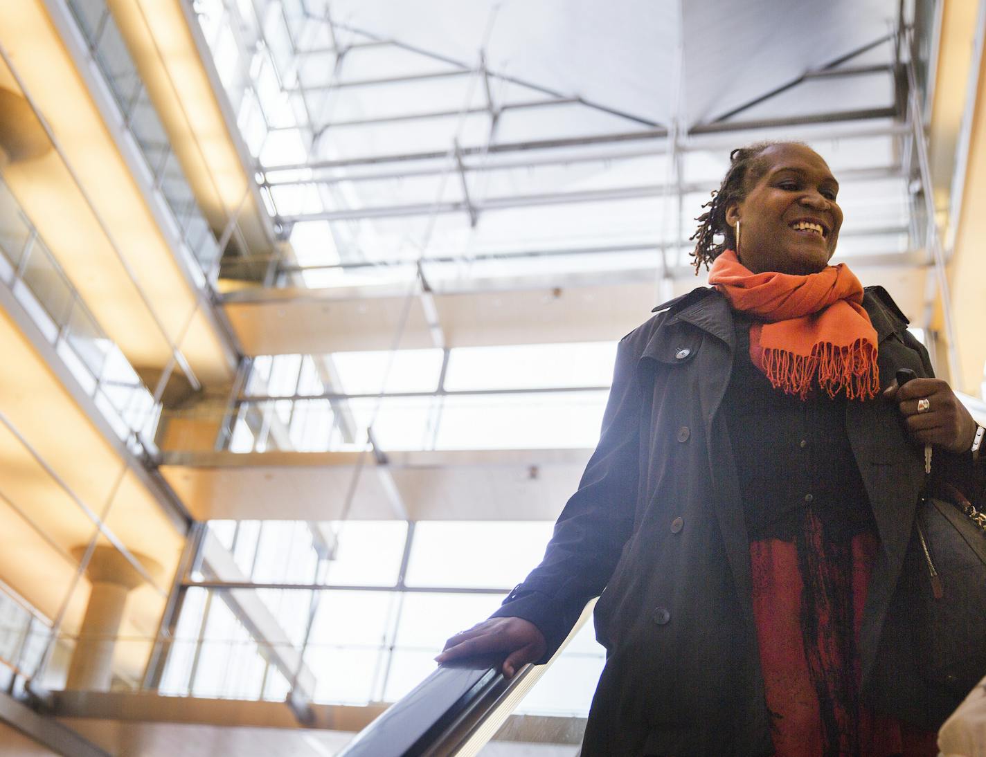 Local writer Andrea Jenkins takes the escalator down after participcating in Queer Voices, an event she co-curated to bring together LGBT poets and writers as part of the Association of Writers & Writing Conference, at the Minneapolis Central Library in downtown Minneapolis on Thursday, April 9, 2015. ] LEILA NAVIDI leila.navidi@startribune.com /