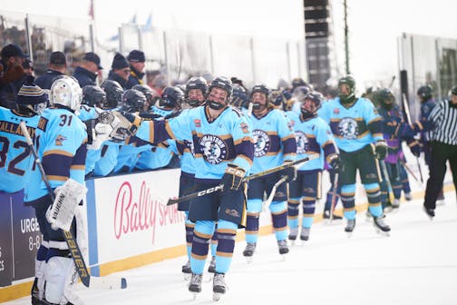 Hermantown's Joshua Kauppinen 19, leads his line on a congratulatory lap past their bench after scoring the game's first goal against Mahtomedi on Hockey Day in Minnesota.