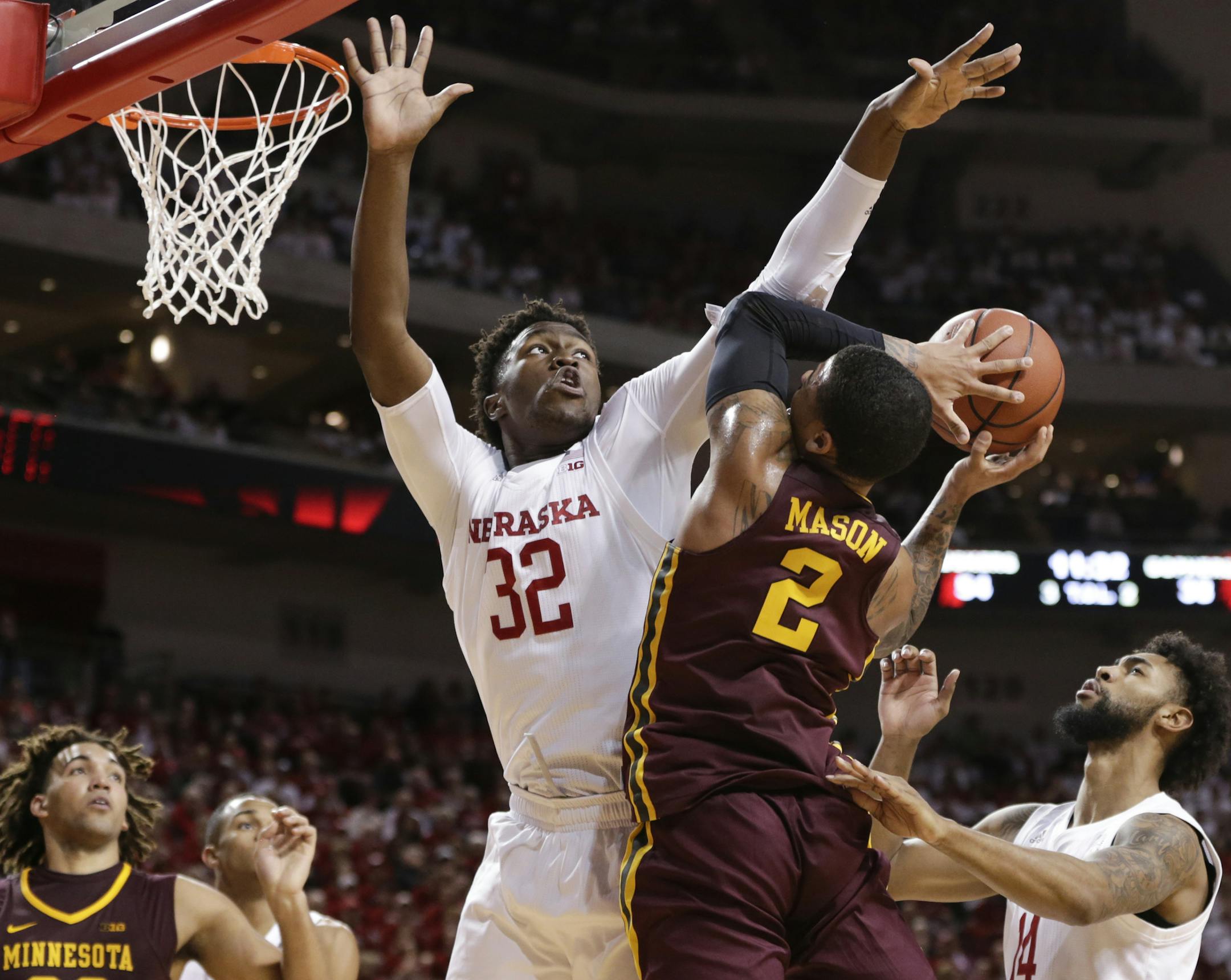 Minnesota's Nate Mason (2) is defended by Nebraska's Jordy Tshimanga (32) and Isaac Copeland (14) during the second half of an NCAA college basketball game in Lincoln, Neb., Tuesday, Dec. 5, 2017. Nebraska won 78-68. (AP Photo/Nati Harnik)